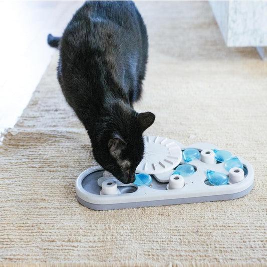 Black cat playing with the Catstages Nina Ottosson Rainy Day Puzzle & Play