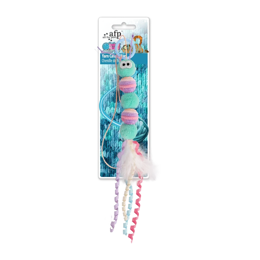 Yarn caterpillar cat toy: green plush with pink and cream yarn pom details