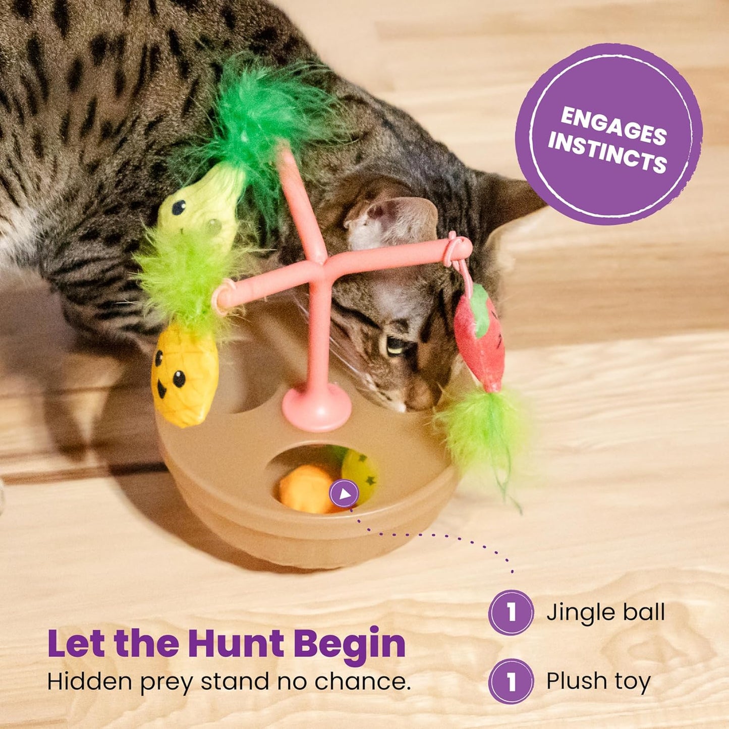 Close-up of tabby cat batting fruit-bowl wobbling toy with fuzzy green topper and plush fruit