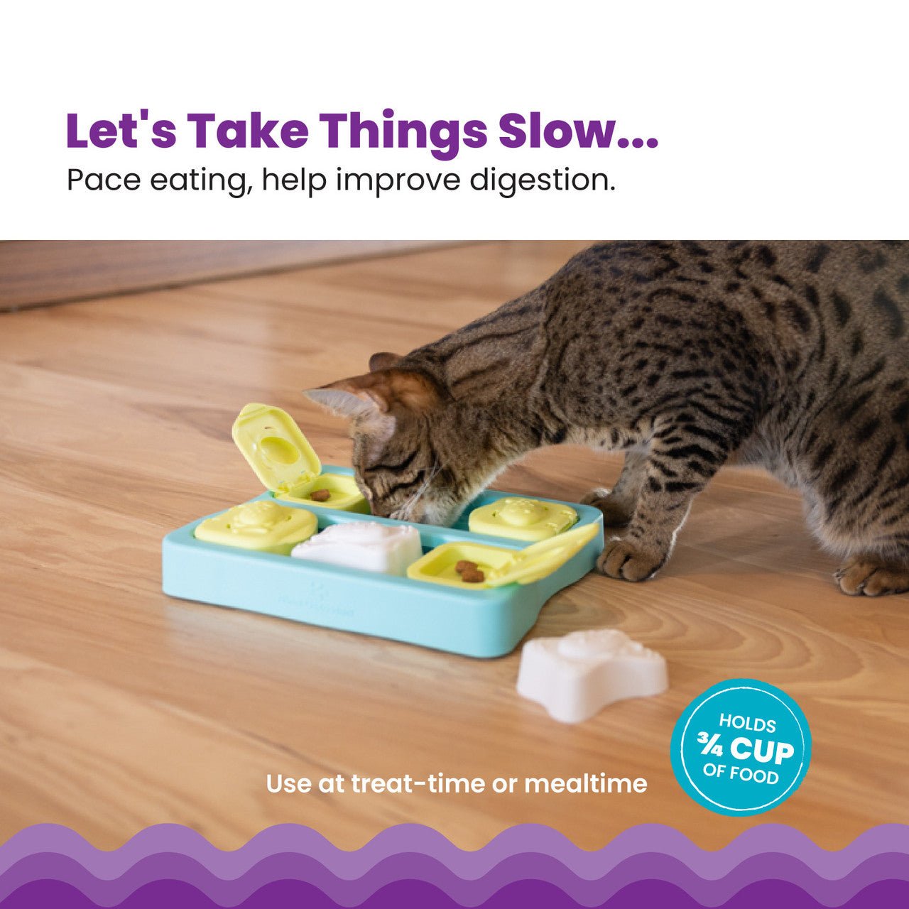 Blue cat treat cube puzzle with green blocks and white covers, with tabby cat