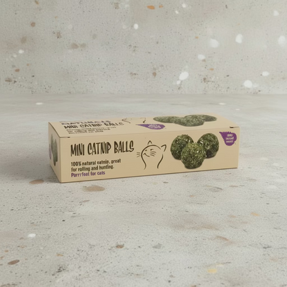 Mini catnip ball box with natural green balls on a light speckled surface