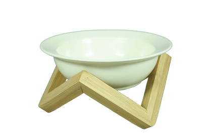 Elevated ceramic cat bowl with bamboo stand in cream