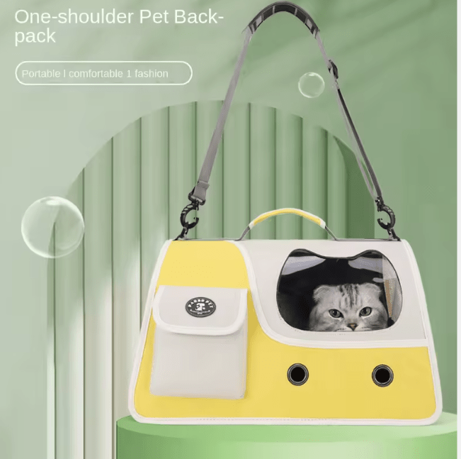 Yellow foldable cat carrier with front window and one-shoulder strap; cat inside