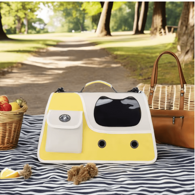 Yellow foldable cat carrier with front mesh window and side storage pocket outdoors