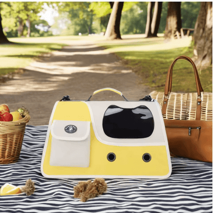 Yellow foldable cat carrier with front mesh window and side storage pocket outdoors