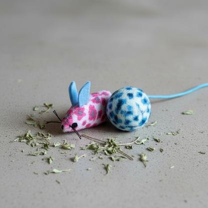 Pink plush mouse, blue-and-white ball, and blue string
