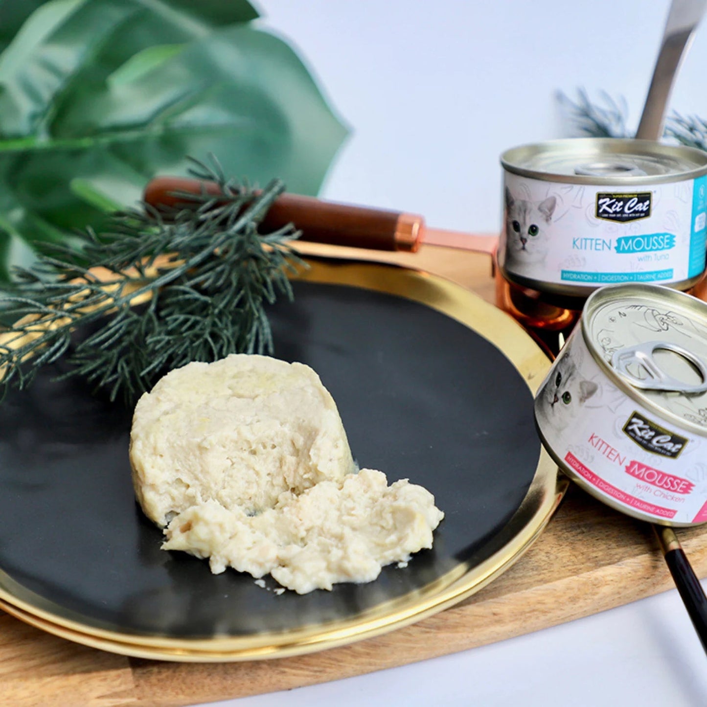 Cream cat mousse on a plate with Kit Cat chicken mousse and kitten mousse cans