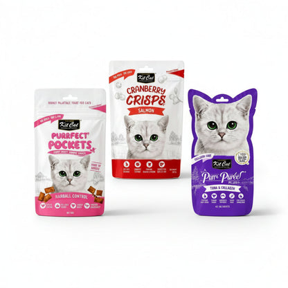 The Snack Committee bundle with Kit Cat Purrfect Pockets, Cranberry Crisps and Purr Puree Plus on ivory display blocks.