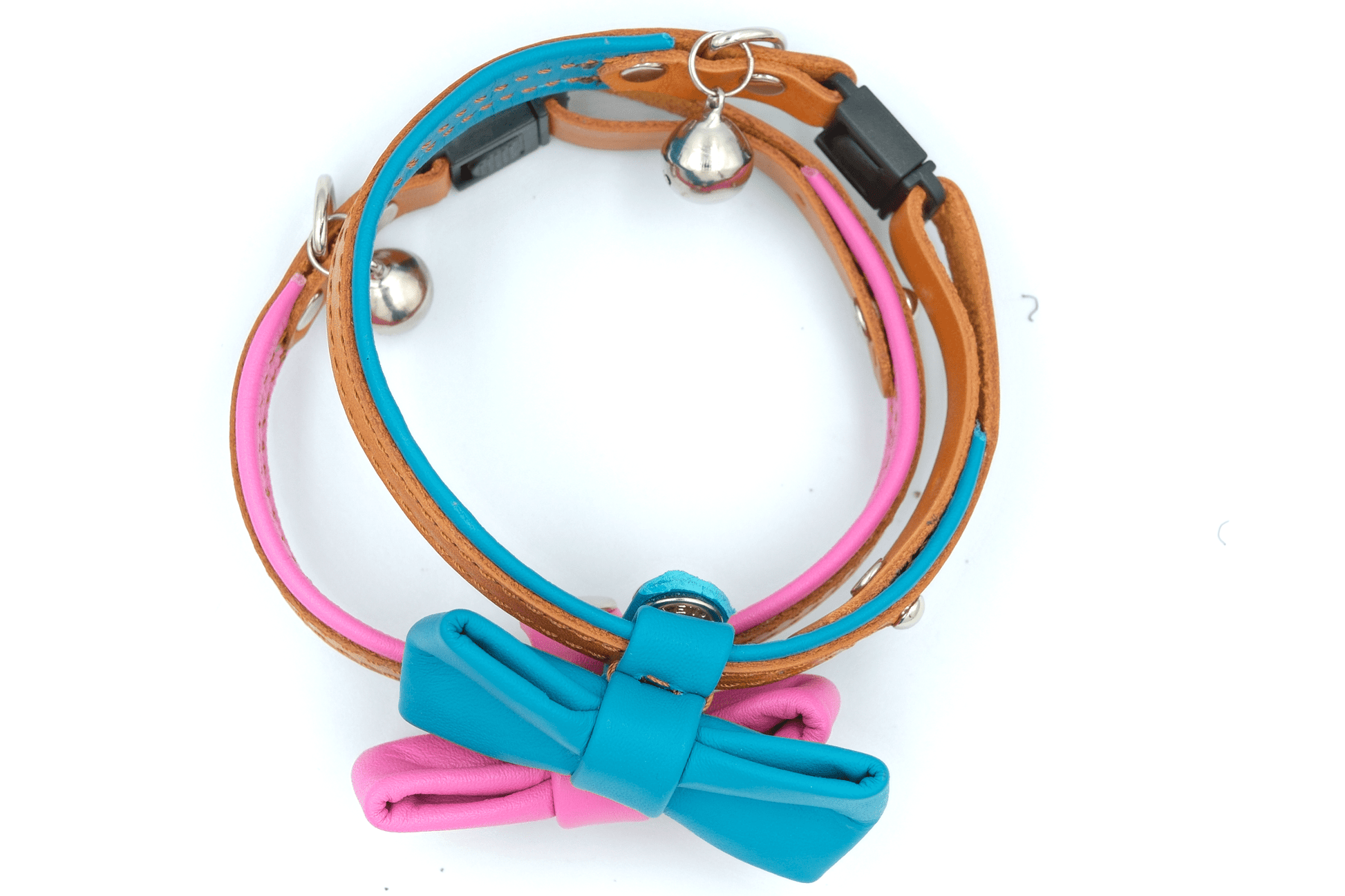 Leather cat collar with blue-pink bowtie and metal bell charm on adjustable strap.