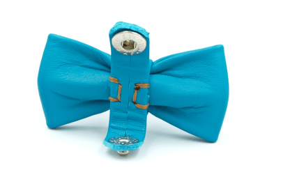 Blue leather bowtie accessory with bell charm and sewn attachment strap