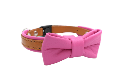 Pink leather cat collar with oversized bow and metal buckle, bell not visible