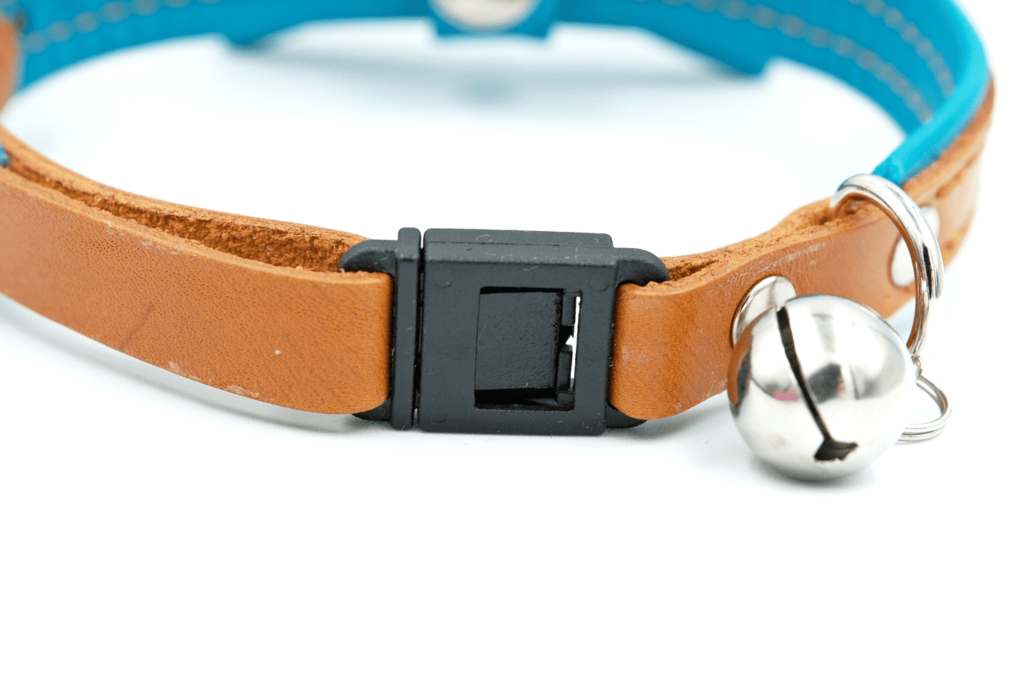 Blue leather cat collar close-up with black clasp and silver bell ring