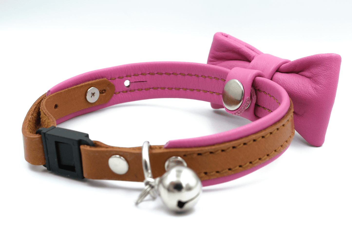 Pink leather cat collar with bow, silver bell, and adjustable holes detail