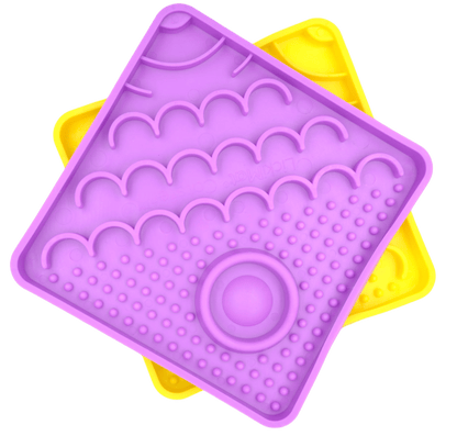 Purple LickiMat Catster slow feeder with raised bumps and oval center