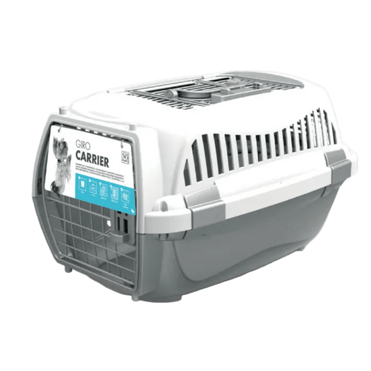 White pet carrier side view with front grille and carry handle; blue label panel visible.