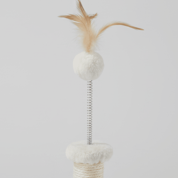 Small kitten cat tree with cream posts, white pom balls, and feather toy on top