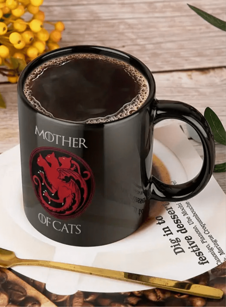 Black ceramic coffee mug with red cat emblem and 'MOTHER OF CATS' text