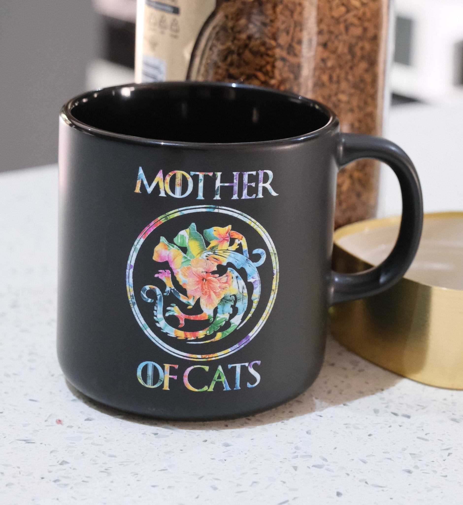 Black Mother of Cats mug with colorful floral cat wreath graphic on front