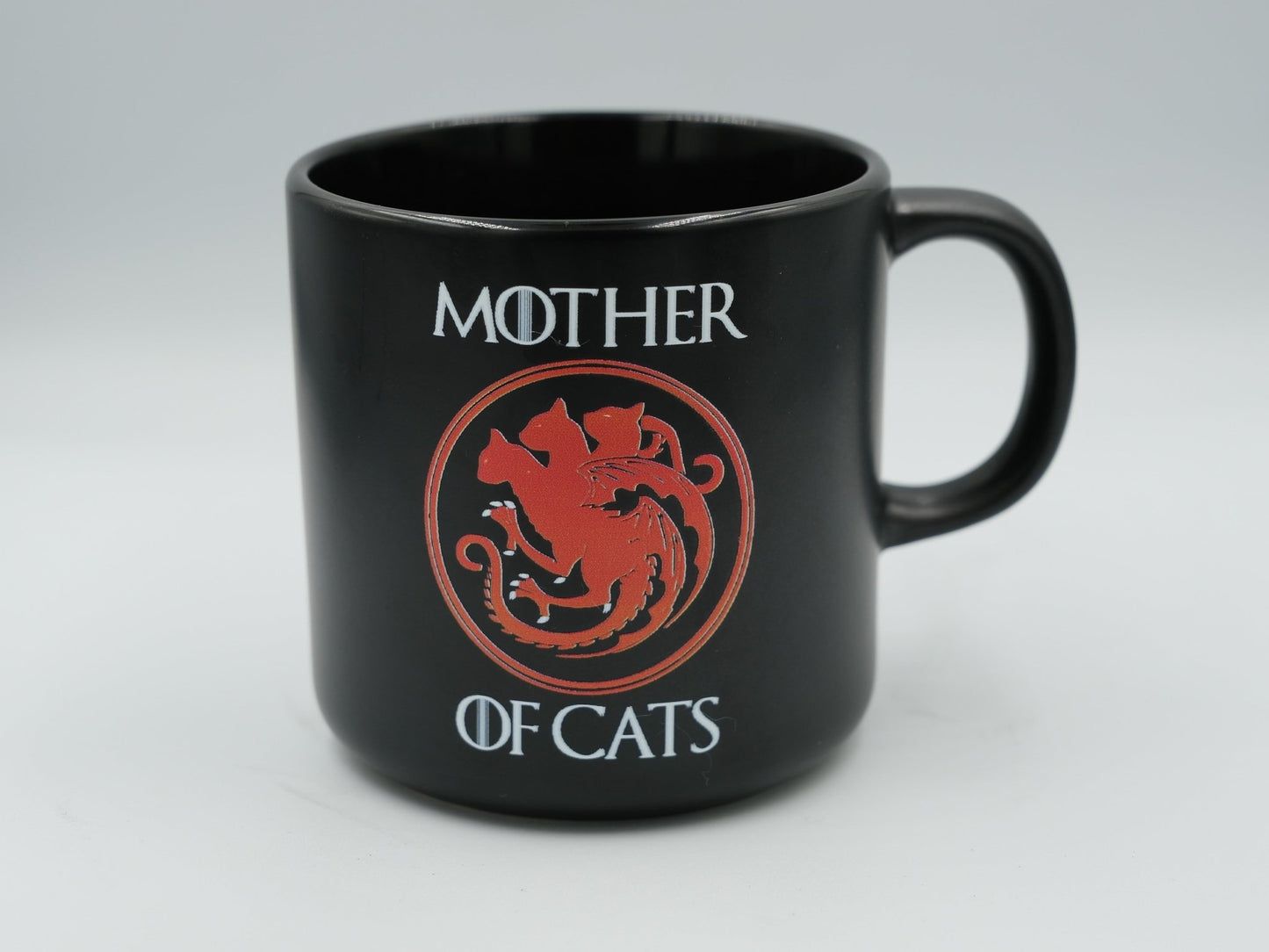 Black Mother of Cats mug with red cat emblem inside round seal