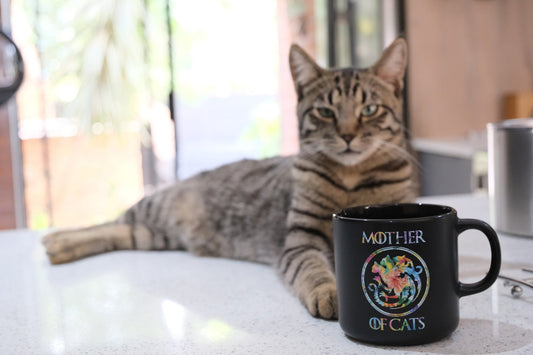 Black Mother of Cats mug with colorful floral cat wreath graphic on front