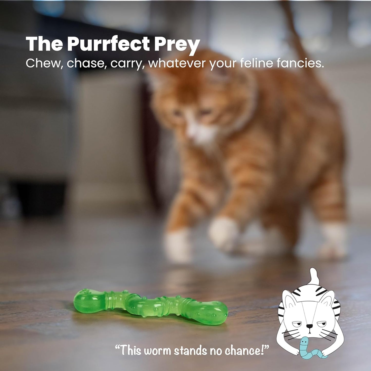 Green wiggle worm toy on the floor with an orange tabby cat nearby, blurred.