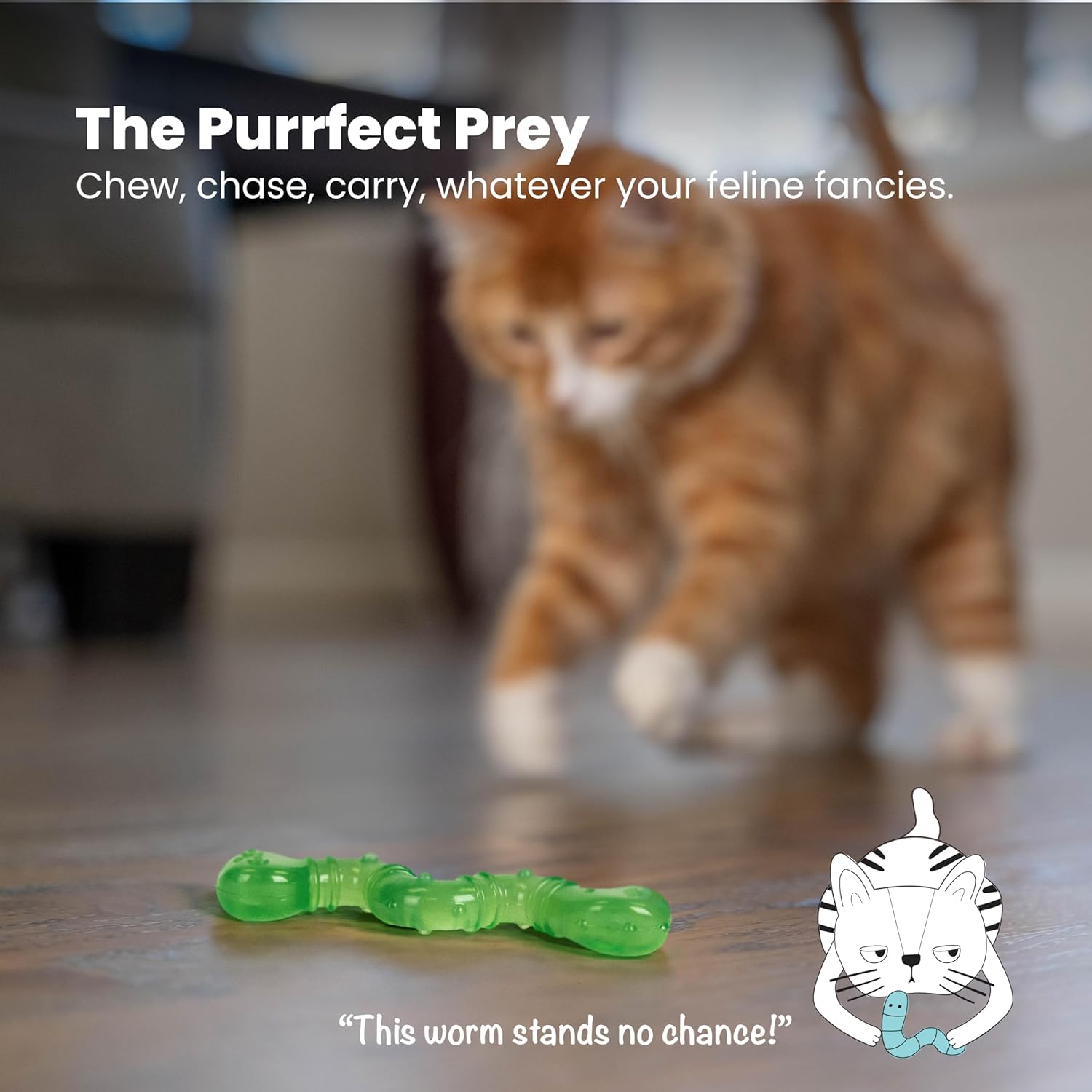 Green wiggle worm toy on the floor with an orange tabby cat nearby, blurred.