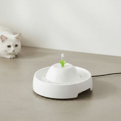 White pet water fountain with domed top and green water spout