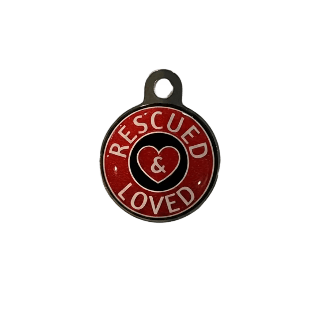 Round metal cat ID tag with 'Rescued & Loved' heart text on red.