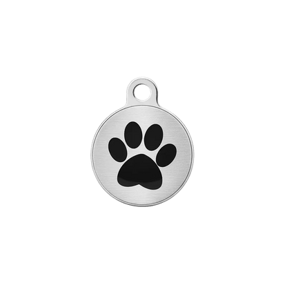 Round metal cat ID tag with black paw print on brushed silver background.