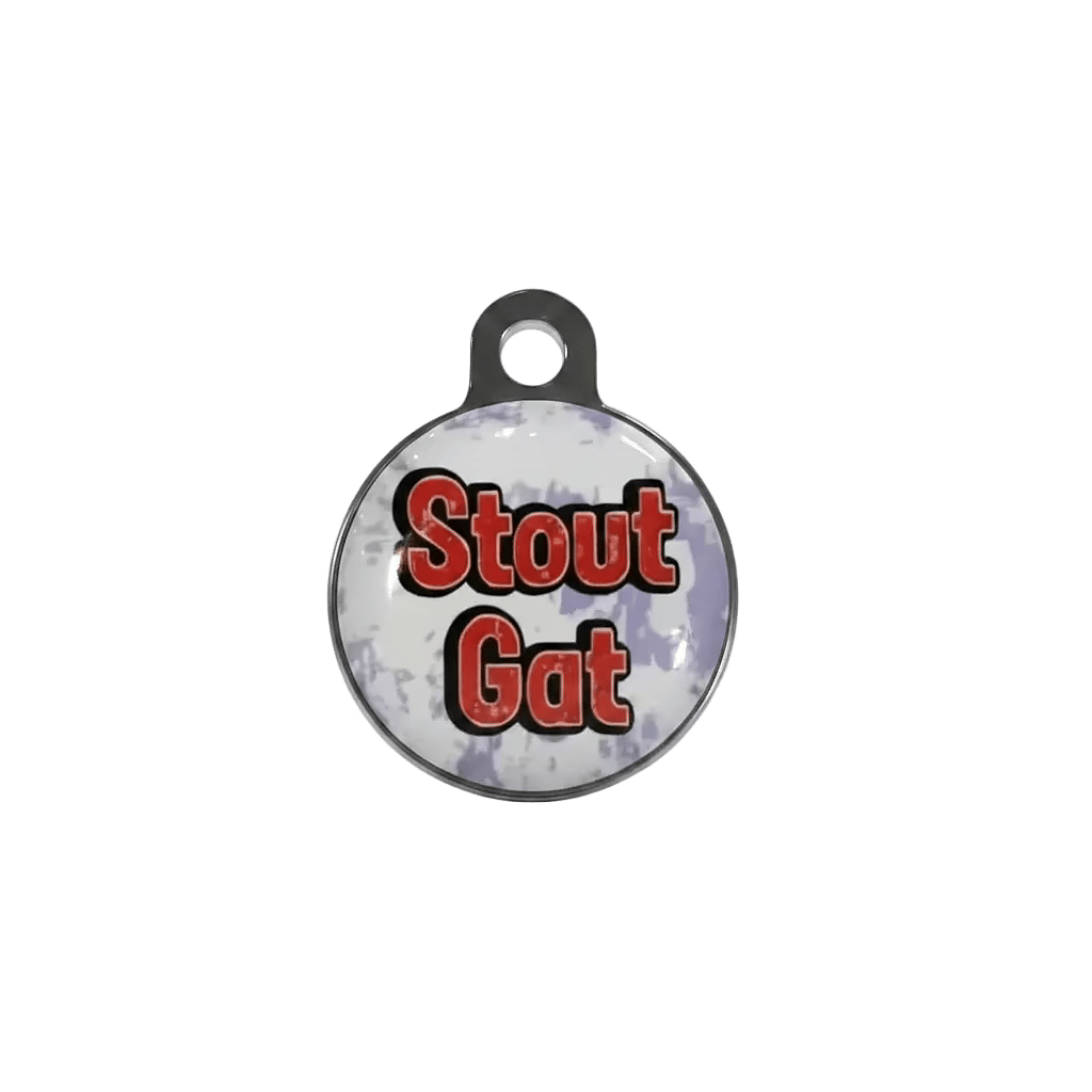 Round metal cat ID tag with 'Stout Gat' text design in red and black.
