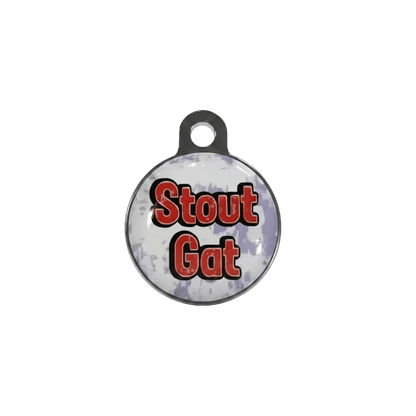 Round metal cat ID tag with 'Stout Gat' text design in red and black.