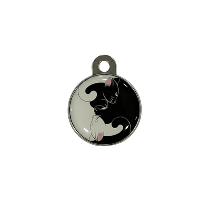 Round metal cat ID tag with yin-yang cat illustration in black and white.