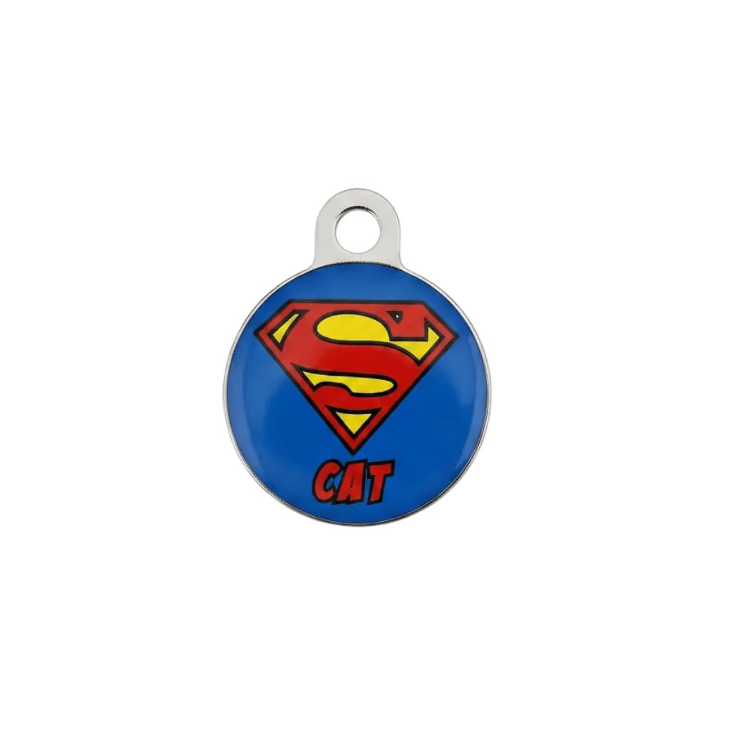 Round metal cat ID tag with Superman-style emblem and 'CAT' text on blue.