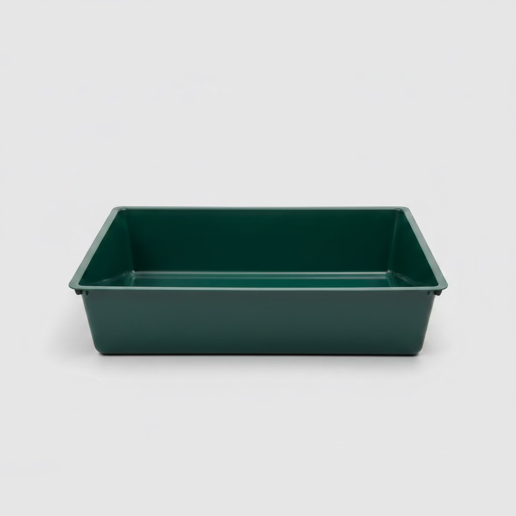 Green plastic cat litter tray with low sides and open top