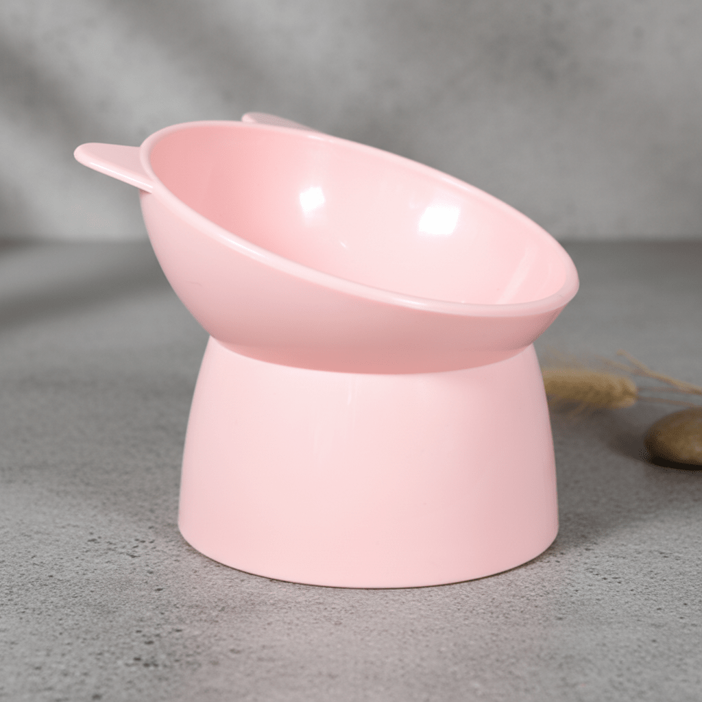 Raised cat feeding bowl in light pink with side handle detail