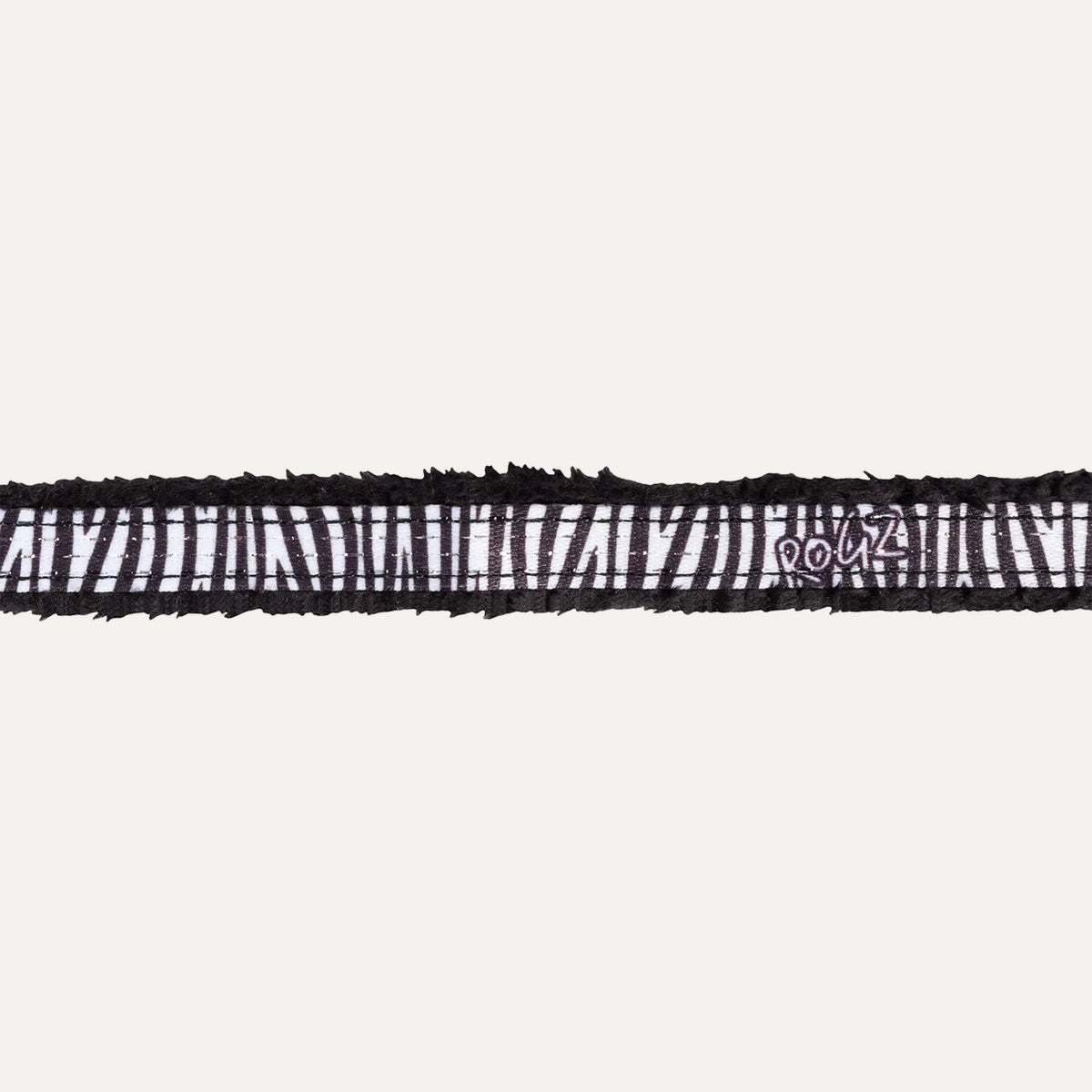 Close-up of black zebra patterned padded edge on cat safety collar.