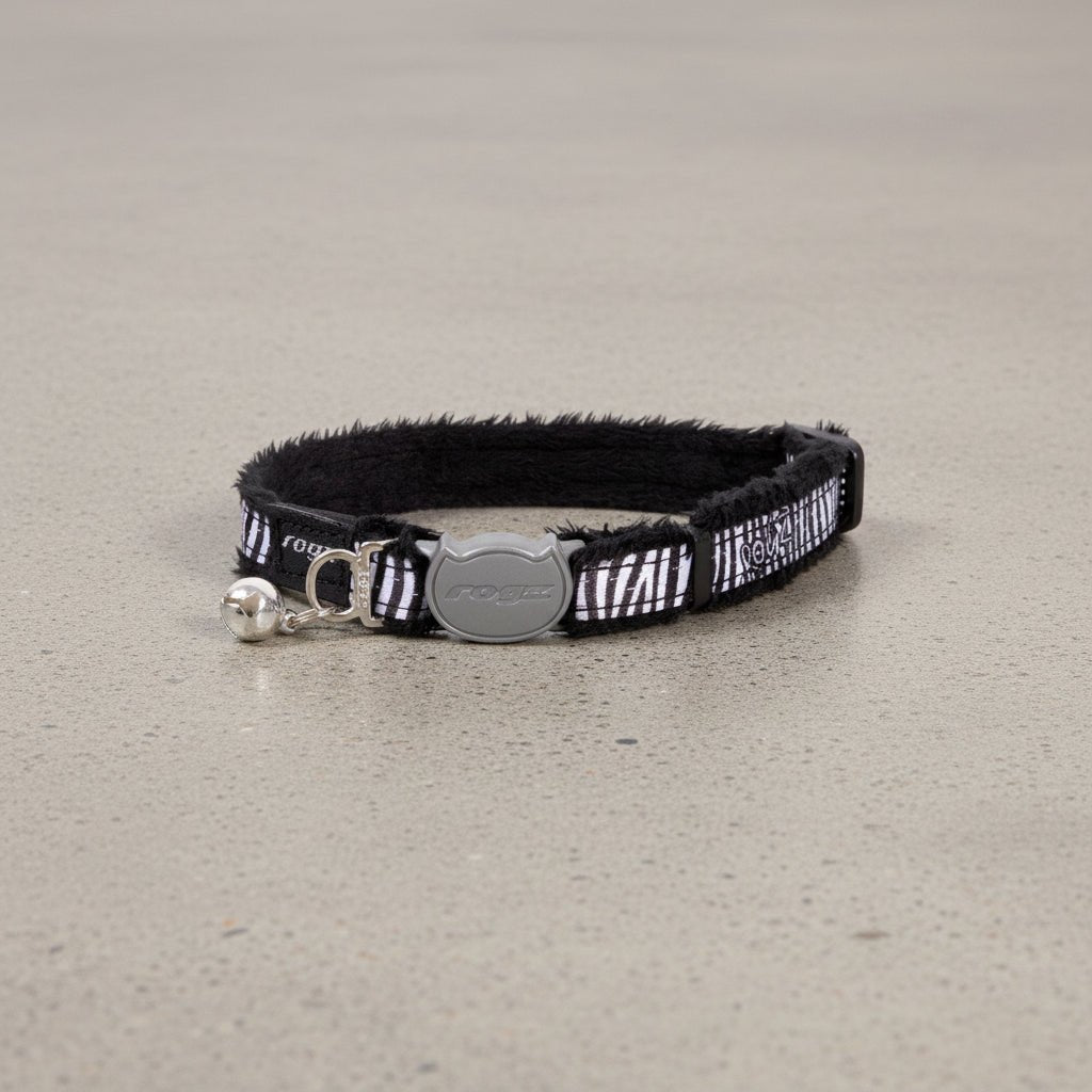 Black cat safety collar with zebra pattern, silver buckle, and small bell attachment.