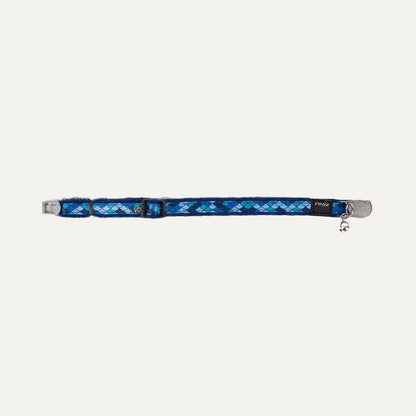 Flat lay of blue cat safety collar with padded lining, silver buckle, and bell.
