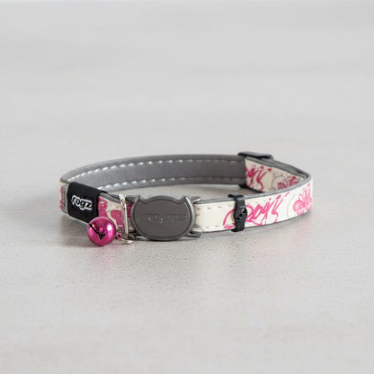 Safety release cat collar with pink butterfly print, gray clasp, and pink bell