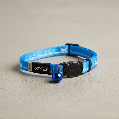 Blue cat collar with black buckle, rogz patch, and hanging bell