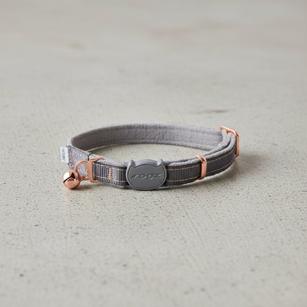 Grey cat safety collar with bell, adjustable strap, and rogz logo buckle