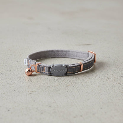 Grey cat safety collar with bell, adjustable strap, and rogz logo buckle