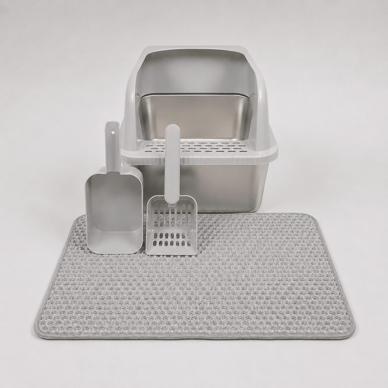 White high-wall cat litter box with scoop, rake, and textured anti-slip mat