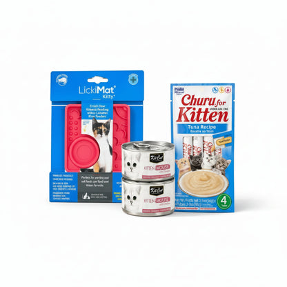 The First Feast kitten bundle with LickiMat Kitty, two Kit Cat Kitten Mousse cans and an INABA Churu Kitten four-pack on ivory display blocks.