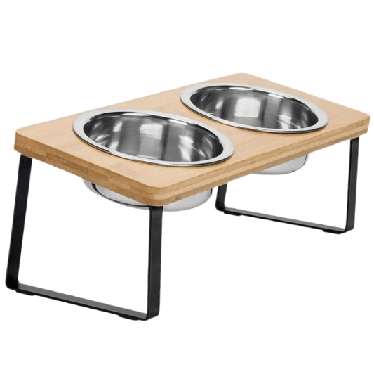 Elevated cat feeder with two stainless steel bowls on light wood stand and black legs