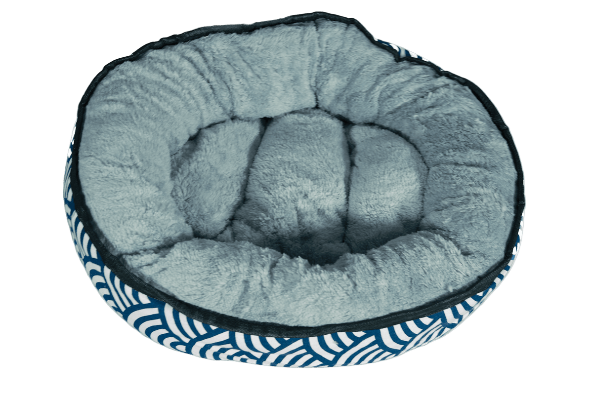 Reversible plush kitten bed with light gray cushioned interior and blue wave sides