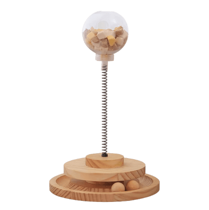 Wooden interactive cat treat dispenser with clear dome and spring base, slow feeder holes