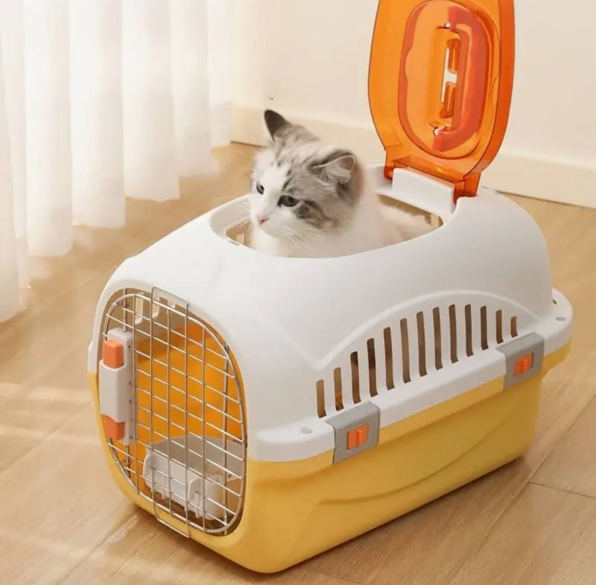White top-load ventilated cat carrier with front door open and orange side access